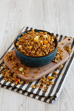 Crispy Granola with Tropical Fruits in a Bowl, side view.