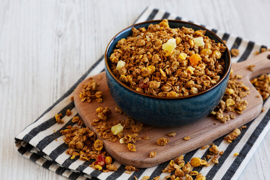 Crispy Granola with Tropical Fruits in a Bowl, side view. Copy space.