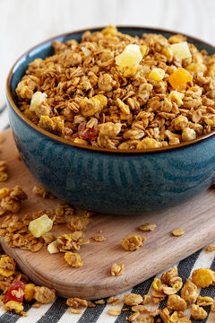 Crispy Granola with Tropical Fruits in a Bowl, side view.