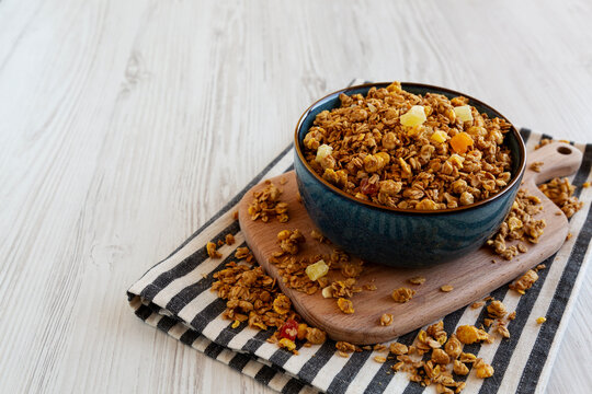 Crispy Granola with Tropical Fruits in a Bowl, side view. Copy space.