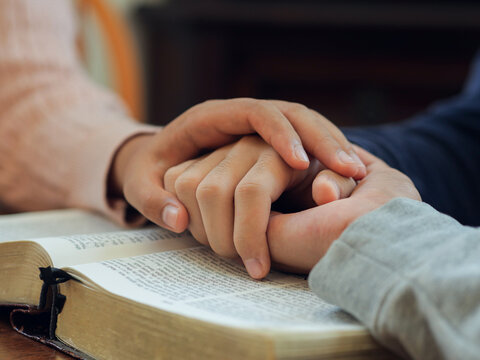 Group of people praying. Christian worship and pray. Christian group of people holding hands praying worships together to believe