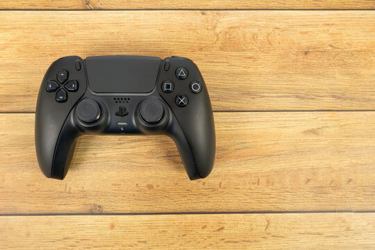 Bogota, Colombia - August 2026 Black ps5 dualsense controller on wooden table