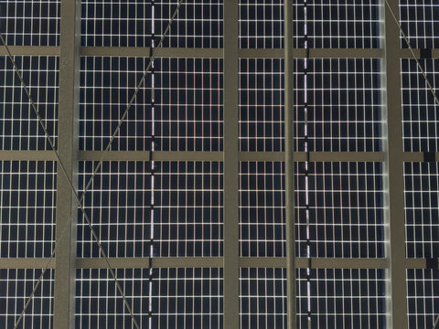 Factory hall with solar panels on roof, renewable energy for industrial Texture