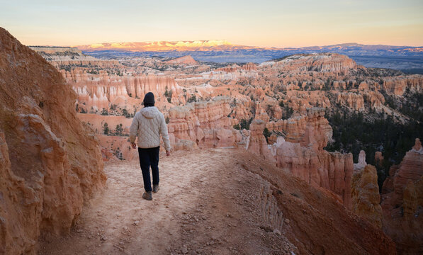 Young man hiking Navajo Loop Trail at sunset. Bryce Canyon National Park. Utah. USA.