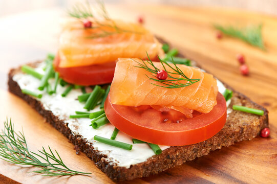 Sandwich with salmon and cream cheese on rye bread, selective focus. Close up. 