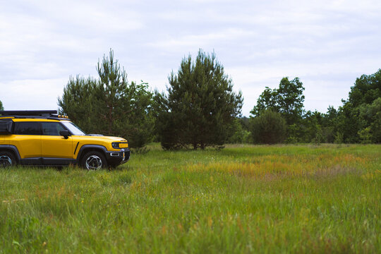 Yellow electric off road vehicle in a grassy field