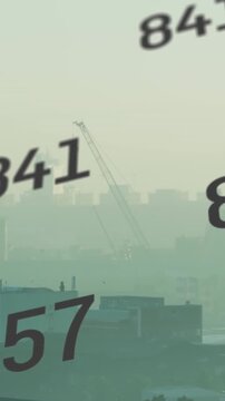 Animation of multiple changing numbers against aerial view of cityscape