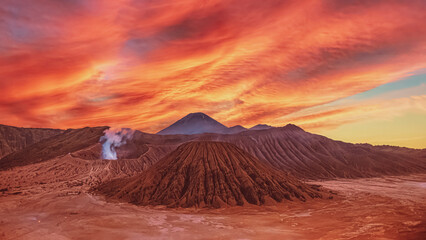 Sunset over volcanic landscape with colorful sky © PixelPlex