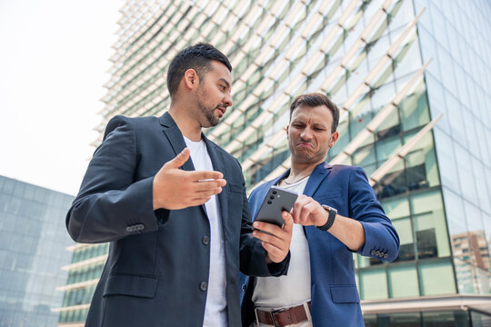 Startup founders discussing business strategy on smartphone