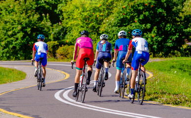 Fototapeta premium Cyclists ride on the bike path in the city Park 