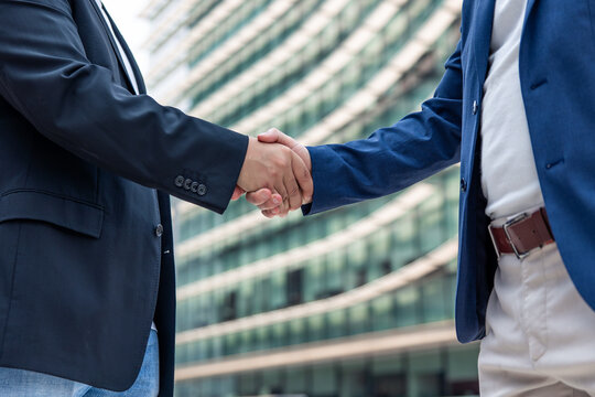 Entrepreneurs shaking hands concluding a technology startup agreement