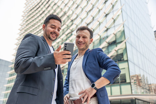 Startup founders discussing business ideas using a smartphone
