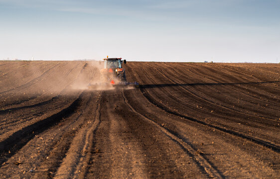 Farmer on tractor Preparing the land for a new crop planting