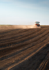 Naklejka premium Farmer on tractor Preparing the land for a new crop planting