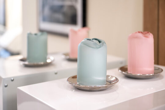 Close up of colored decorative wax candles inside relaxation spa room