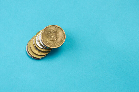 High Angle of Stack Coins Over Blue Background