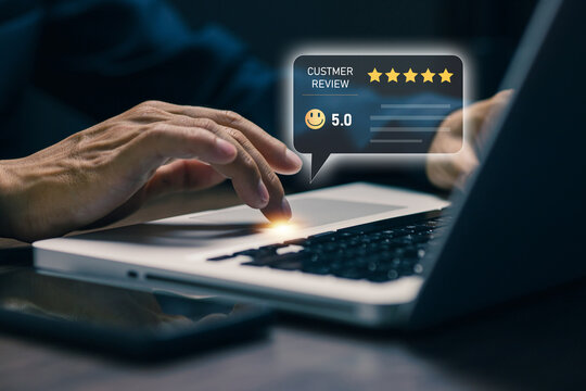 Business user giving a five star customer review on laptop with digital rating interface, representing online feedback, satisfaction, service quality, reputation, and ecommerce experience.