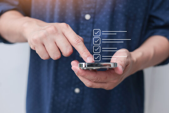 close up man hand use smartphone to check online survey and questionnaire from website for marketing concept