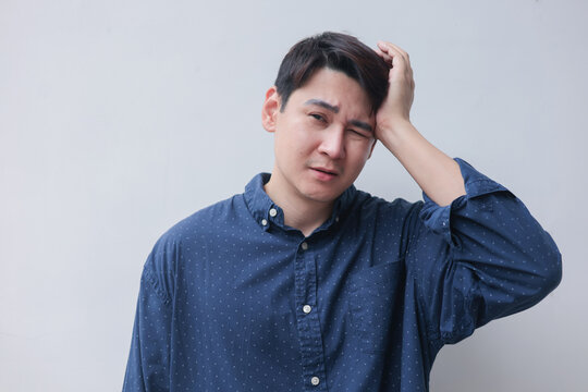close up young asian man massage on head after feel stress symptom or migraine for unhealthy lifestyle concept