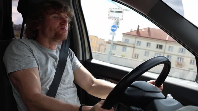 Young novice driver is anxious and overwhelmed while driving through city traffic gripping the steering wheel tightly and worrying about making mistakes on the road ahead
