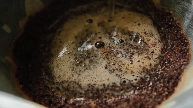 Pouring Hot Water Over Ground Coffee for Drip Brewing