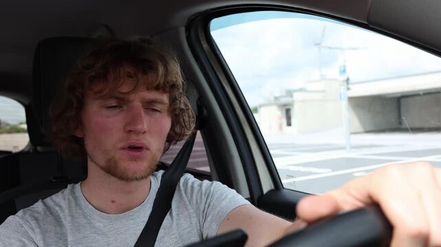 Distracted male driver looks at his smartphone and suddenly brakes hard when something runs into the road creating a dangerous close call after losing focus while driving