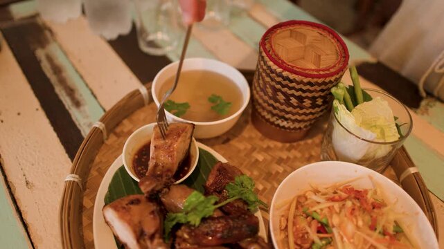 Traditional Thai Isan Meal with Papaya Salad and Grilled Chicken