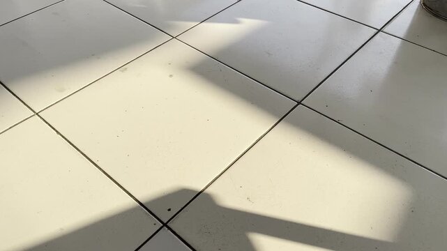 Minimalist white ceramic tiles surface with architectural shadow