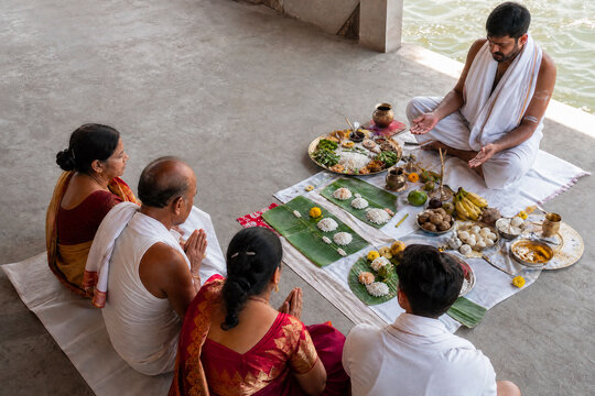 Indian family performing sacred Pitru Paksha ritual with Hindu priest