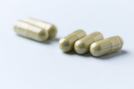 Barley grass capsules. Antioxidants. Concept for a healthy dietary supplemen capsules. Antioxidants. Concept for a healthy dietary supplementation. Bright background. Soft focus. Close up. Copy space.