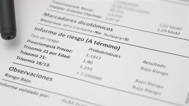 Close up of pen pointing at low risk trisomy 21 18 13 and preeclampsia report