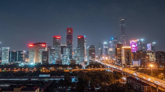 Beijing CBD skyline at night with illuminated skyscrapers and elevated highway traffic in Beijing, China