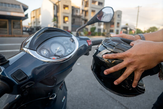 Man getting ready to drive his motorbike, close-up