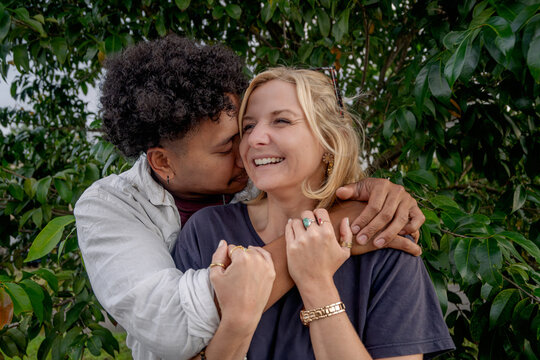 Close up of a man hugging his girlfriend, young happy and in love couple