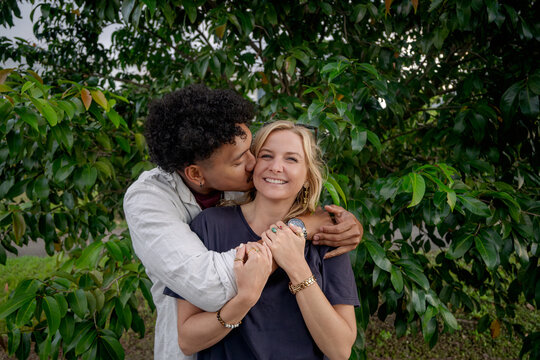 Man kisses girlfriend, young happy and in love couple