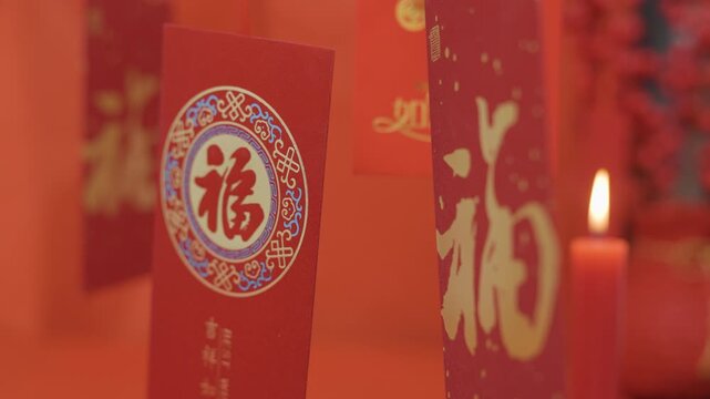 Chinese red envelopes with fortune character and candle for Lunar New Year