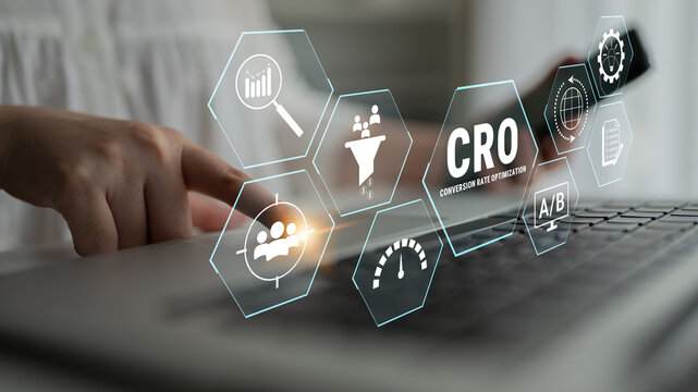 Hands Typing on Laptop with Digital Icons Representing Conversion Rate Optimization Strategies and Analytics in a Bright Office Setting. Glyphic.