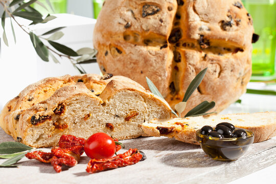 Loaf of bread with olive and tomato, close up