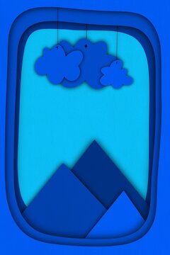 Blue layered papercraft landscape features mountain and hanging cloud