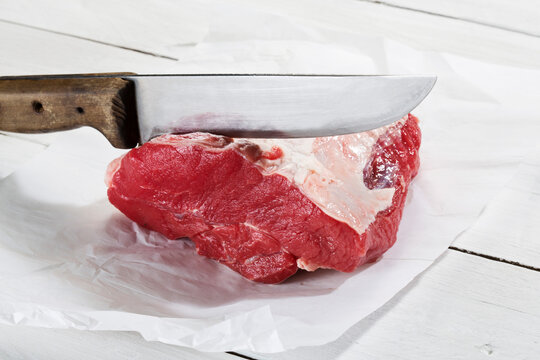 Raw beef for making soup on wax paper, close up