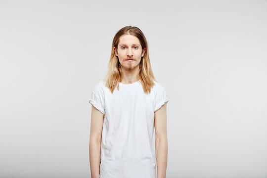 Portrait of young man with long blond hair