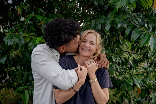 Man kisses girlfriend, young happy and in love couple