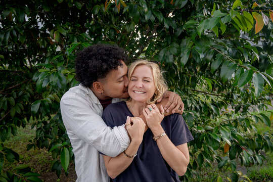 Man kisses girlfriend, young happy and in love couple