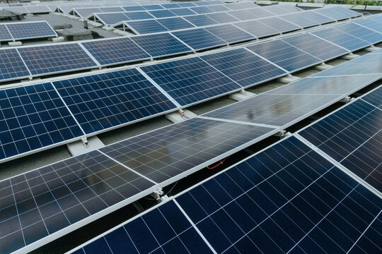 Solar panels generate renewable green energy on a commercial roof