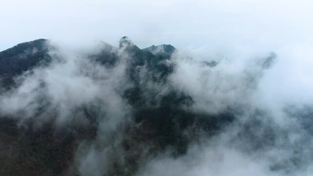 Misty Mountain Peaks Covered by Low Clouds