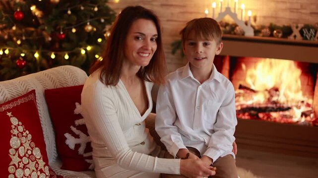 Happy family on Christmas, enjoying some quality time together, kids and adults with pet dog on Christmas eve at home
