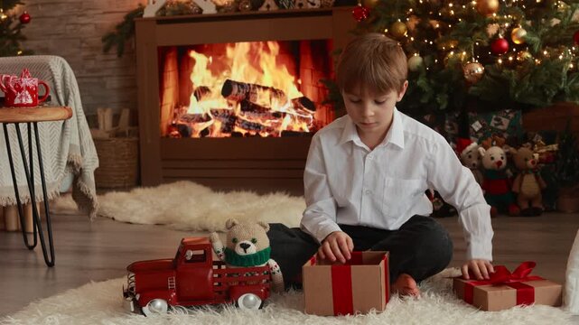 Happy child on Christmas, enjoying some quality time, opening presents, kids and adults with pet dog on Christmas eve in decorated home