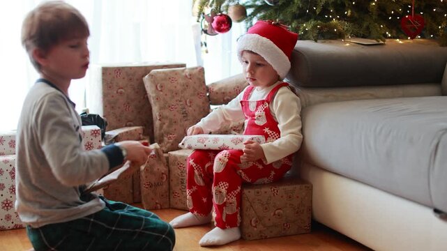 Happy family on Christmas, enjoying some quality time together, kids and adults with pet dog on Christmas eve at home