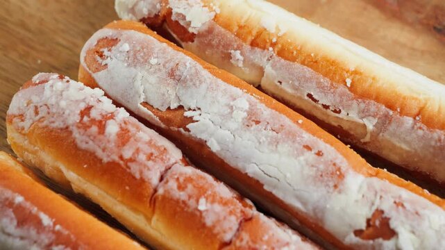 Close-up of traditional Fartons, elongated glazed pastries from Valencia, Spain, a popular sweet served with horchata.