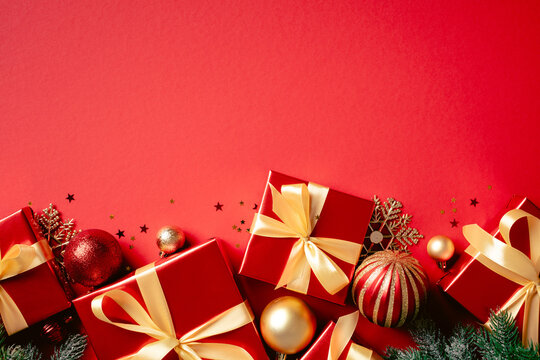 Red Christmas gifts and golden ornaments bottom border on red
